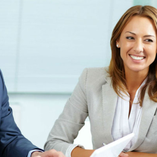 woman smiling at group of people around table